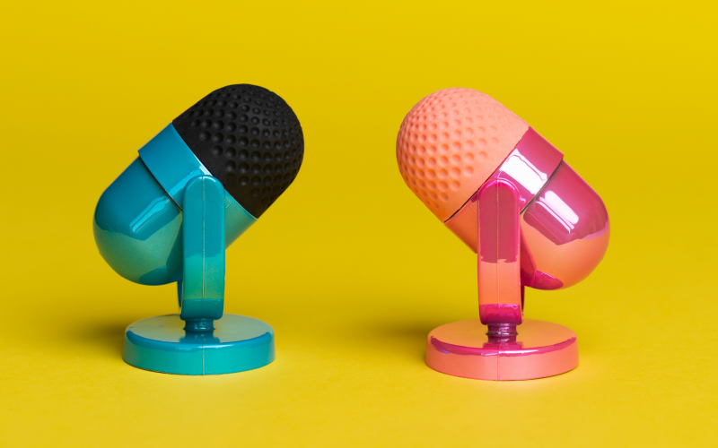 Two microphones facing each other with A YELLLLOW BACKGROUND